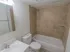 Bathroom with vanity sink, toilet and tiled tub shower at The Lafayette at Valley Forge apartments in King of Prussia, PA.