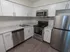 Model kitchen wood-style floors and stainless-steel appliances at The Lafayette at Valley Forge apartments in King of Prussia, PA.