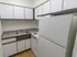 Model kitchen wood-style floors and modern appliances at The Lafayette at Valley Forge apartments in King of Prussia, PA.