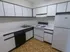 Model kitchen wood-style floors and modern appliances at The Lafayette at Valley Forge apartments in King of Prussia, PA.