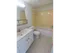 Bathroom with vanity sink, toilet and tiled tub shower at The Lafayette at Valley Forge apartments in King of Prussia, PA.