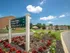 Directory sign to guide visitors in to townhome community surrounded by colorful flowers