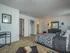 Furnished master bedroom with large closet and black and white decor with red accents
