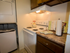 White stove and in-unit laundry in Red Bank Run townhome kitchen