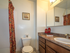 Apartment bathroom with brown vanity and colorful shower curtain