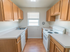 Kitchen with a sunny window and white appliances at Evergreen Club apartments for rent in Broomall, PA