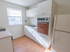 Kitchen with white cabinets and a vintage oven and stovetop at Evergreen Club apartments for rent in Broomall, PA