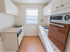 Kitchen with a vintage oven, hardwood floors, and white cabinets at Evergreen Club apartments for rent