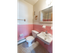 Bathroom with pink tiled walls and a white sink at Evergreen Club apartments for rent in Broomall, PA
