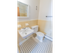Full bathroom with a vintage black and white tile flooring at Evergreen Club apartments for rent