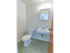 Half bathroom with tile flooring and a white sink with a medicine cabinet at Evergreen Club apartments for rent
