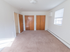 Large bedroom with two closets and a small window at Evergreen Club apartments for rent in Broomall, PA