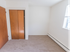 Moderate sized bedroom with two closets and baseboard heating at Evergreen Club apartments for rent