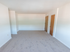 Spacious living room with brown doors and white walls at Evergreen Club apartments for rent in Broomall, PA