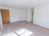 Large living room with beige carpeting and natural light at Evergreen Club apartments for rent in Broomall, PA