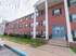 Tall columns outside of a red brick residential building at Evergreen Club apartments for rent in Broomall, PA