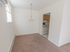 Dining room leading into kitchen with carpet flooring and a hanging chandelier at Evergreen Club apartments for rent