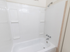 White tub and shower with built in shelves