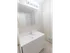 Renovated bathroom with white sink and vanity and mirror medicine cabinet