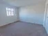 Moderate-sized bedroom with large window and carpeting