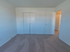 Second bedroom with closet and beige carpeting