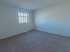 Townhome bedroom with sunny window, carpeting, and heating vent