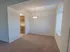 Dining room with large window, hanging light fixture, and carpet flooring