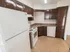 Model kitchen with wood cabinets and modern appliances at Winslow House Apartments in Blackwood, NJ.