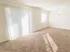 Carpeted living room and dining area with sliding glass patio doors at Winslow House Apartments in Blackwood, NJ.