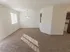 Dining area with chandelier and pass-through window to the kitchen at Winslow House Apartments in Blackwood, NJ.
