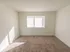 Carpeted bedroom with a large window at Winslow House Apartments in Blackwood, NJ.
