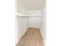 Carpeted walk-in closet with clothes bar and shelf at Winslow House Apartments in Blackwood, NJ.