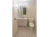 Model bathroom with tiled floors, vanity sink and toilet at Winslow House Apartments in Blackwood, NJ.