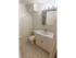 Model bathroom with tiled floors, vanity sink and toilet at Winslow House Apartments in Blackwood, NJ.