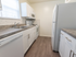 Sample Model kitchen with tiled flooring, wood cabinets and modern appliances at Wyntre Brooke apartments in West Chester, PA.
