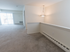 Carpeted living room with sliding glass patio doors at Wyntre Brooke apartments in West Chester, PA.