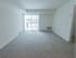 Carpeted living room with sliding glass patio doors at Wyntre Brooke apartments in West Chester, PA.