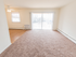Carpeted living room and dining area with wood-style flooring at Polo Ridge apartments in Burlington, NJ.