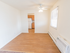 Model dining area with wood-style flooring looking into the kitchen at Polo Ridge apartments in Burlington, NJ.