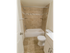 Model bathroom with vanity sink, toilet, and tiled tub shower at Polo Ridge apartments in Burlington, NJ.