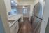 Model kitchen with wood-style flooring, stainless steel appliances and a large breakfast bar at Paoli Place Apartments in Paoli, PA.