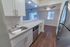 Model kitchen tiled backsplash, stainless steel appliances and a large breakfast bar at Paoli Place Apartments in Paoli, PA.