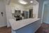 Model kitchen with stainless steel appliances and a large breakfast bar at Paoli Place Apartments in Paoli, PA.