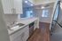 Model kitchen tiled backsplash, stainless steel appliances and a large breakfast bar at Paoli Place Apartments in Paoli, PA.