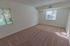 Carpeted model bedroom with large windows at Paoli Place Apartments in Paoli, PA.