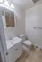 Model bathroom with vanity sink and toilet at Paoli Place Apartments in Paoli, PA.