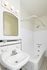 Charming bathroom with vintage fixtures, tiled walls, and elegant lighting, offering a classic touch to modern living.