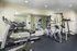 Modern apartment gym with state-of-the-art cardio equipment and sleek mirrored walls for an energizing workout experience.
