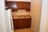 Cozy kitchen with elegant wooden cabinets, sleek granite countertops, and modern tile flooring.