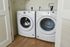 Modern laundry area featuring sleek white washer and dryer set for efficient home living.